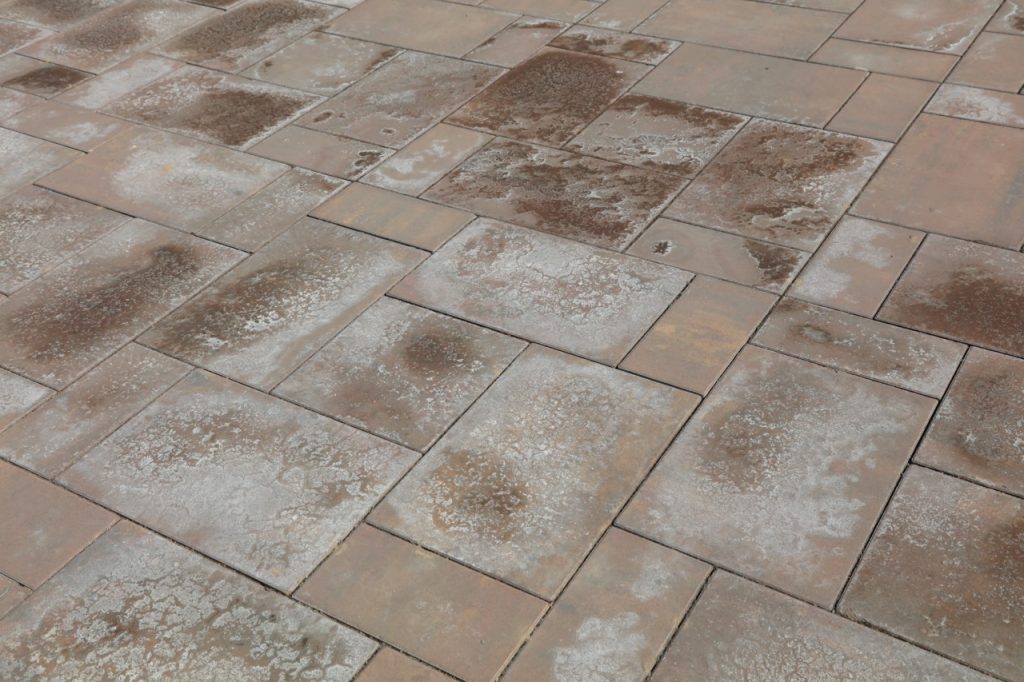 wet and dry salt stains on tile flooring inside a business